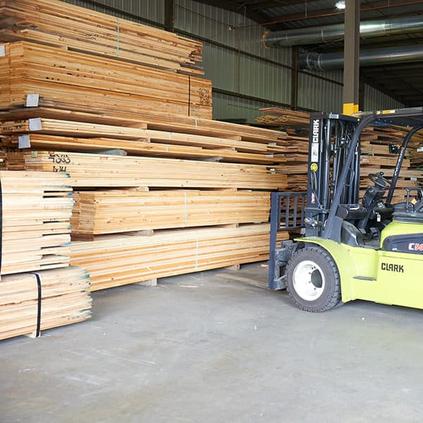 Fork lift next to timber planks