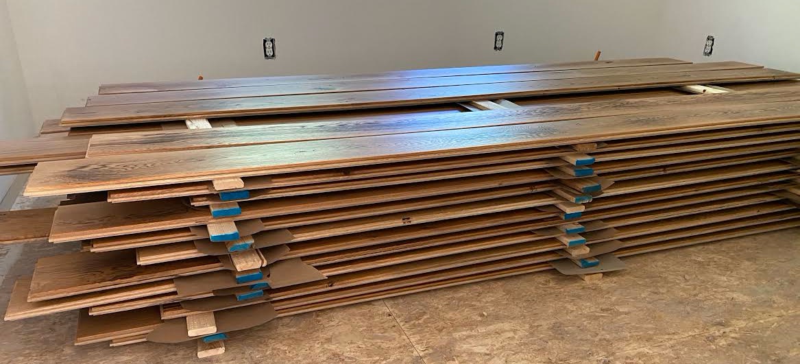 Hardwood flooring stacked for acclimation