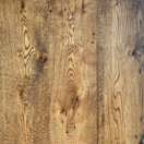 Sawmark Texturing lends the surface of the planks a tactile quality that hints at the wood's journey from the forest. These distinctive marks also play with light and shadow, beautifully accentuating the natural grain and adding depth to Covered Bridge's dazzling range of browns and golds.