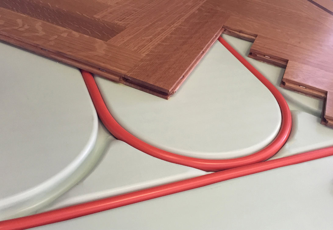 Radiant heat tubing in a subfloor panel under tongue and groove oak flooring
